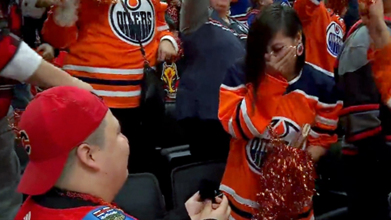 Flames fan proposes to Oilers fan in the crowd at Game 4