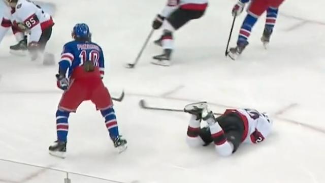 Travis Hamonic in agony after taking puck to the throat