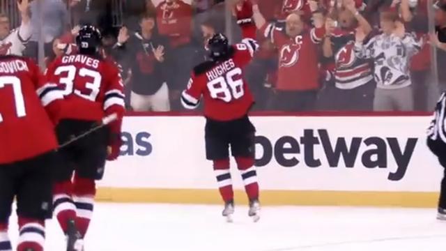 Jack Hughes throws his stick into the crowd after incredible OT winner.